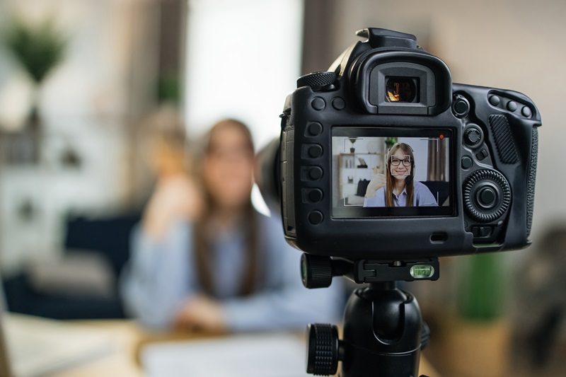 Female influencer using camera for leading live streaming