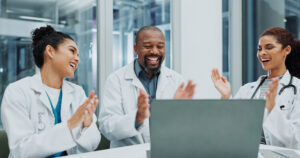 Medical practice team celebrating results from their healthcare marketing agency